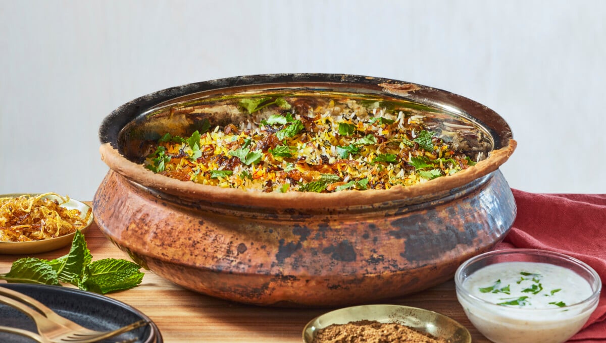 A metal pot of chicken biryani.