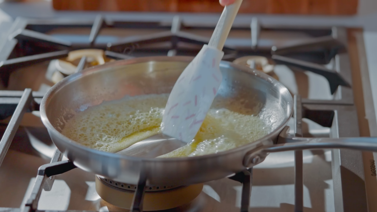 A stainless steel pan of melted butter.