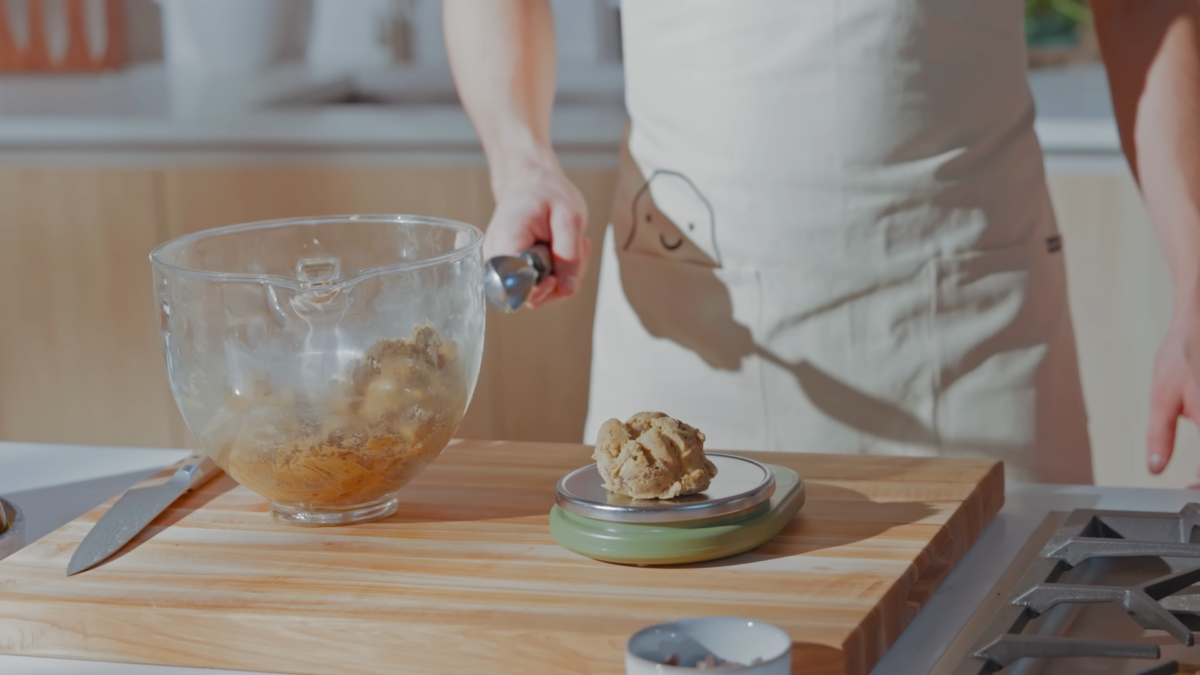 A ball of cookie dough portioned out on a food scale.