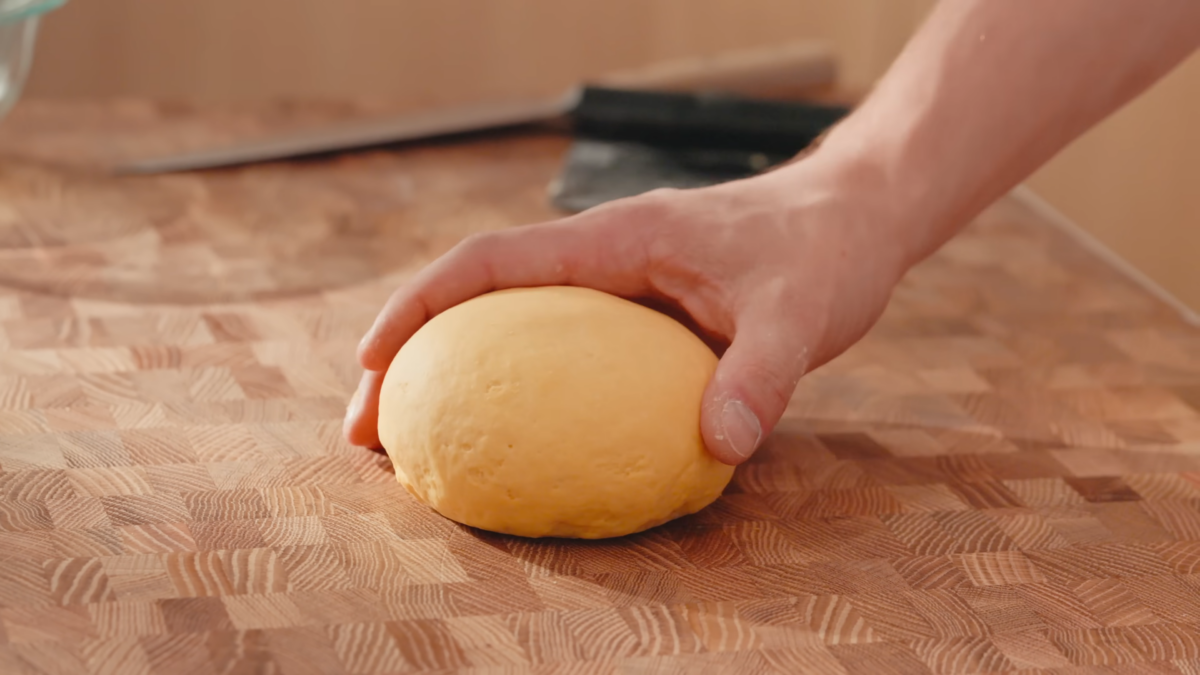 A man holding a ball of dough.
