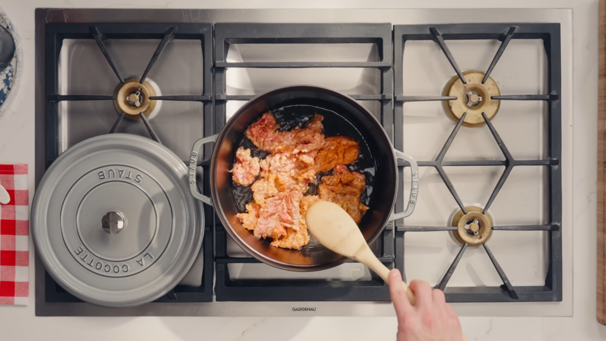 Italian sausage cooking in a pot.