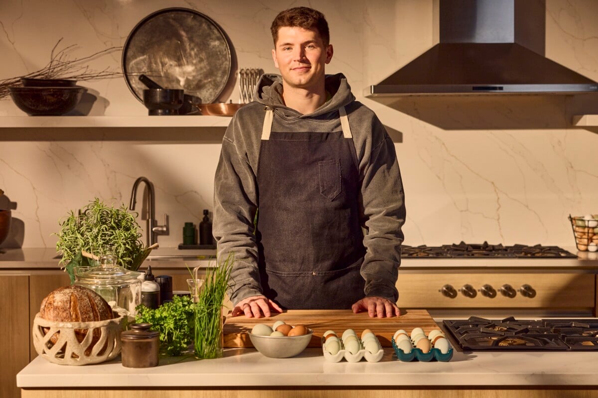 A chef standing behind a counter preparing to cook.
