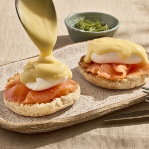 Two biscuits topped with smoked salmon, poached eggs, and hollandaise sauce.
