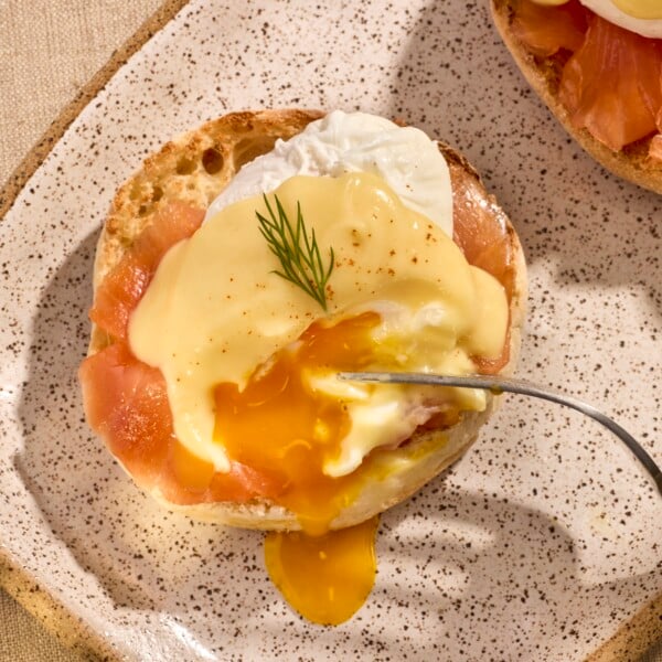 A poached egg and smoked salmon on a biscuit topped with hollandaise sauce.