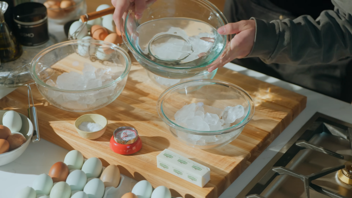 A man pouring water into a bowl of ice.