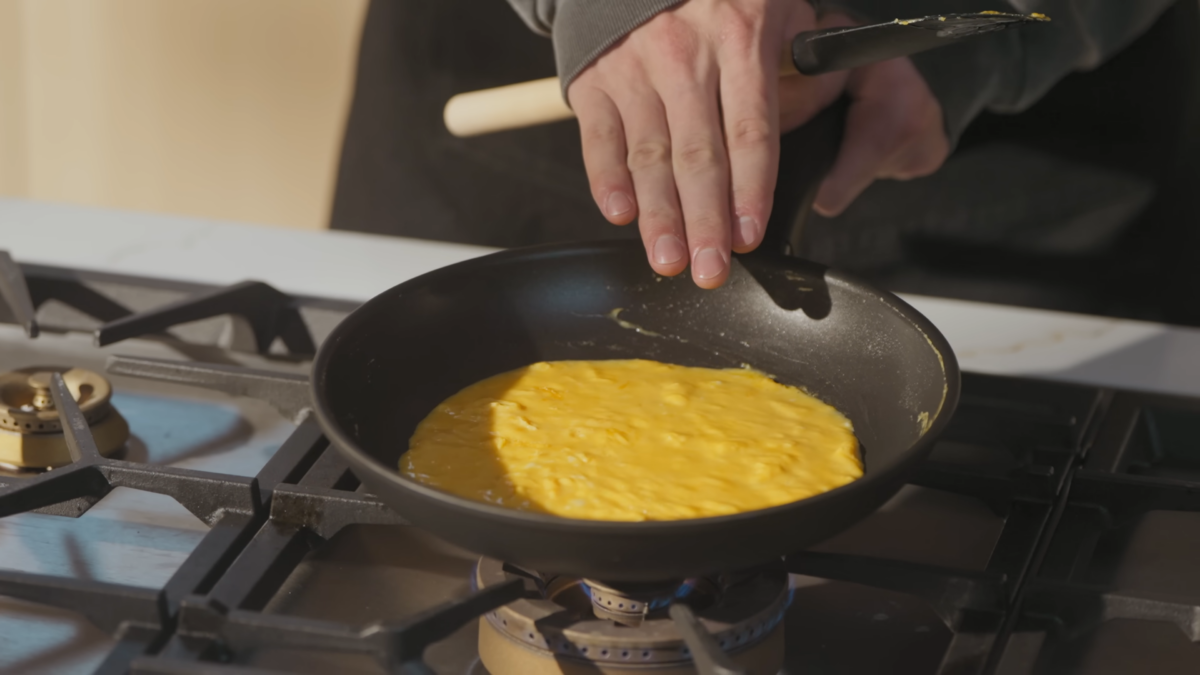 An omelette egg base cooking in a pan.