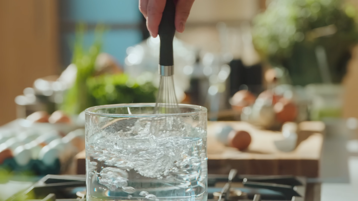 Whisking a glass of boiling water.