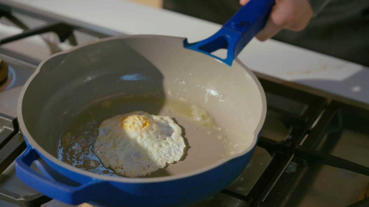 An over easy egg in a pan.