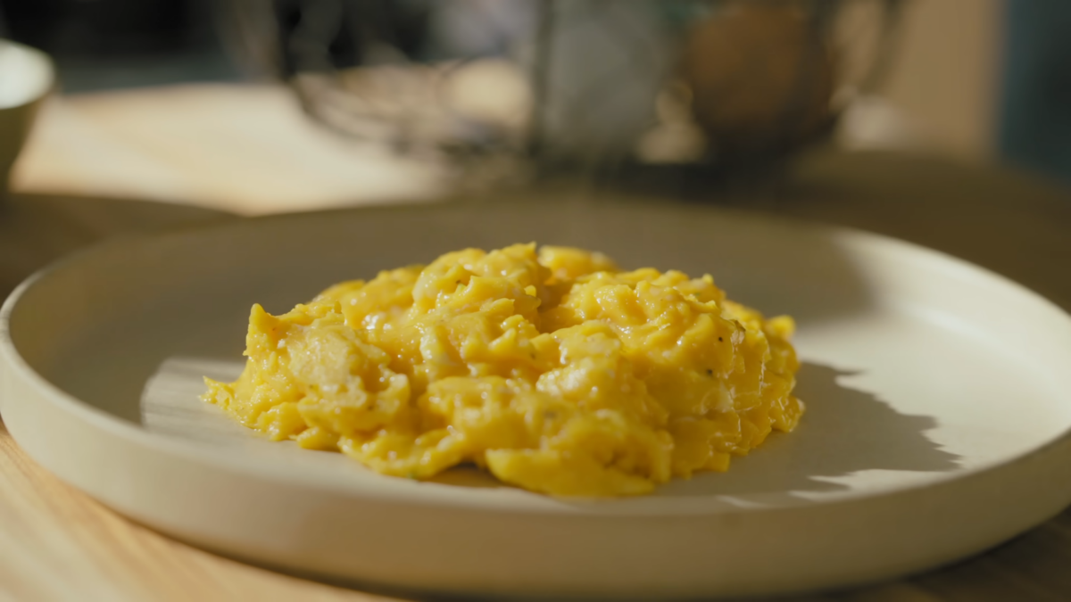 Scrambled eggs on a white plate.