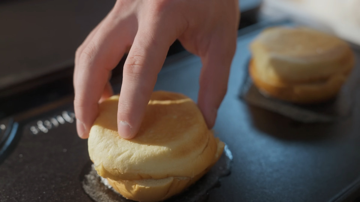 Buns toasting on acast iron griddle.
