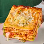 A spatula holding a serving of lasagna.