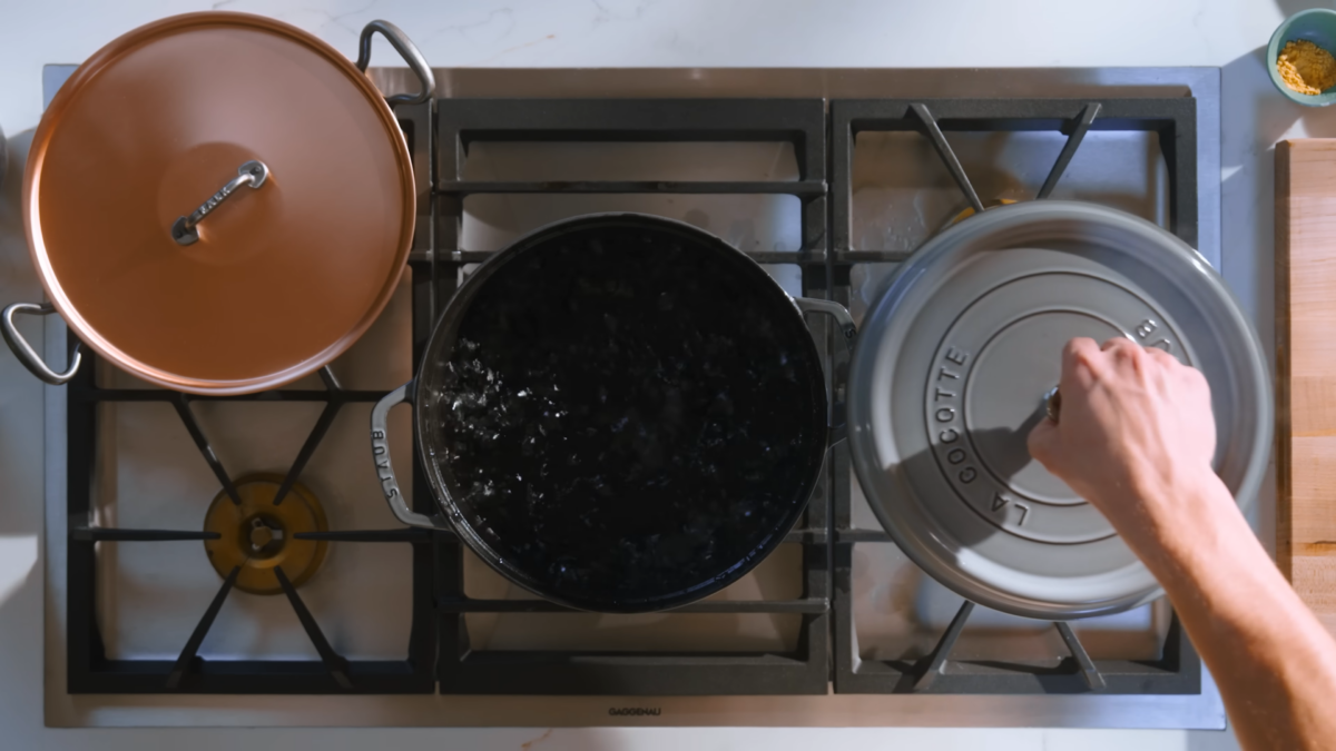 A pot of boiling water on a stove.