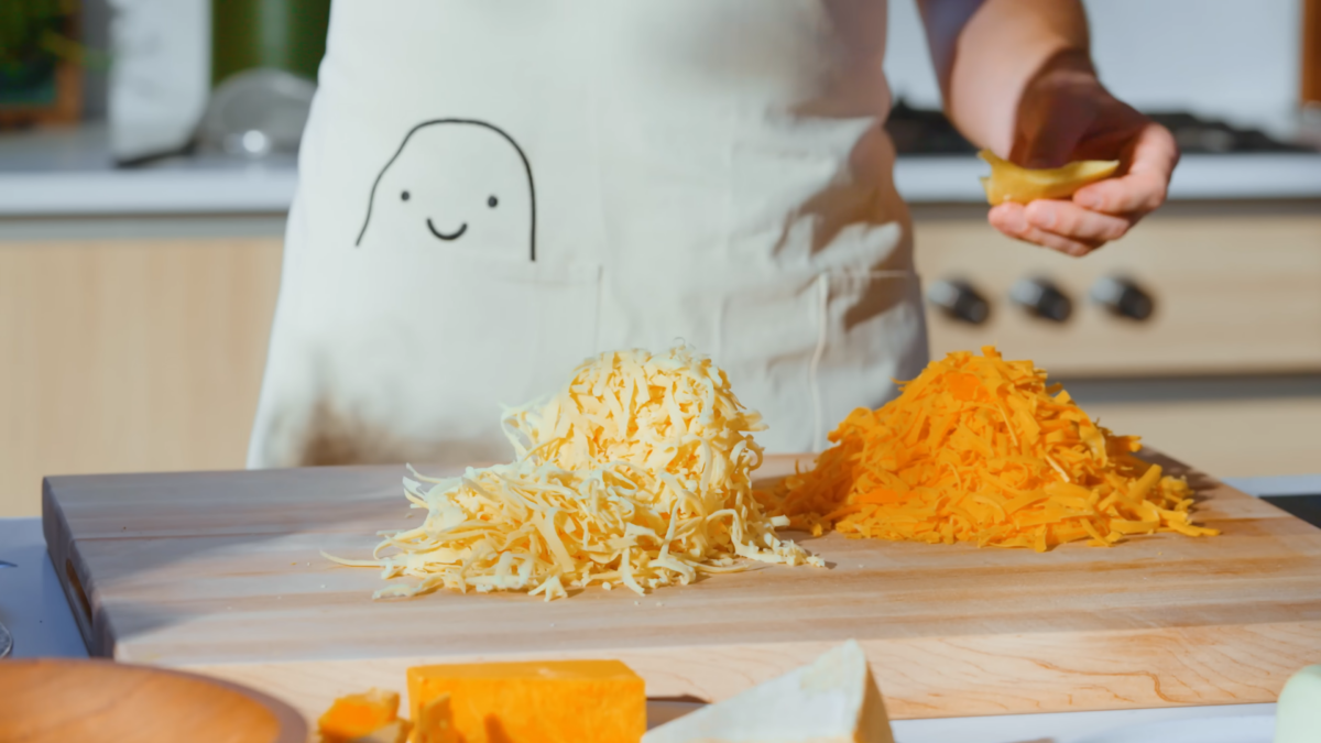 Freshly grated cheese on a cutting board.
