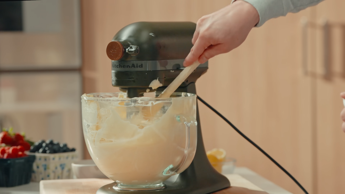 Cream cheese blended in a glass mixing bowl.