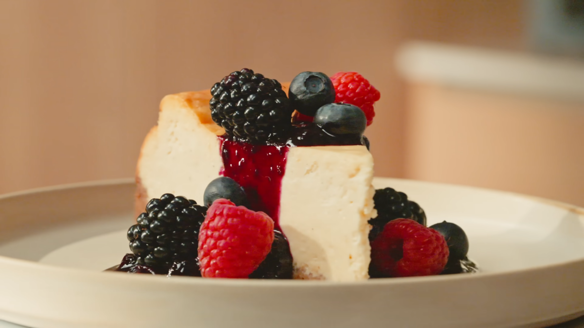 Cheesecake topped with blueberry sauce and fresh berries.