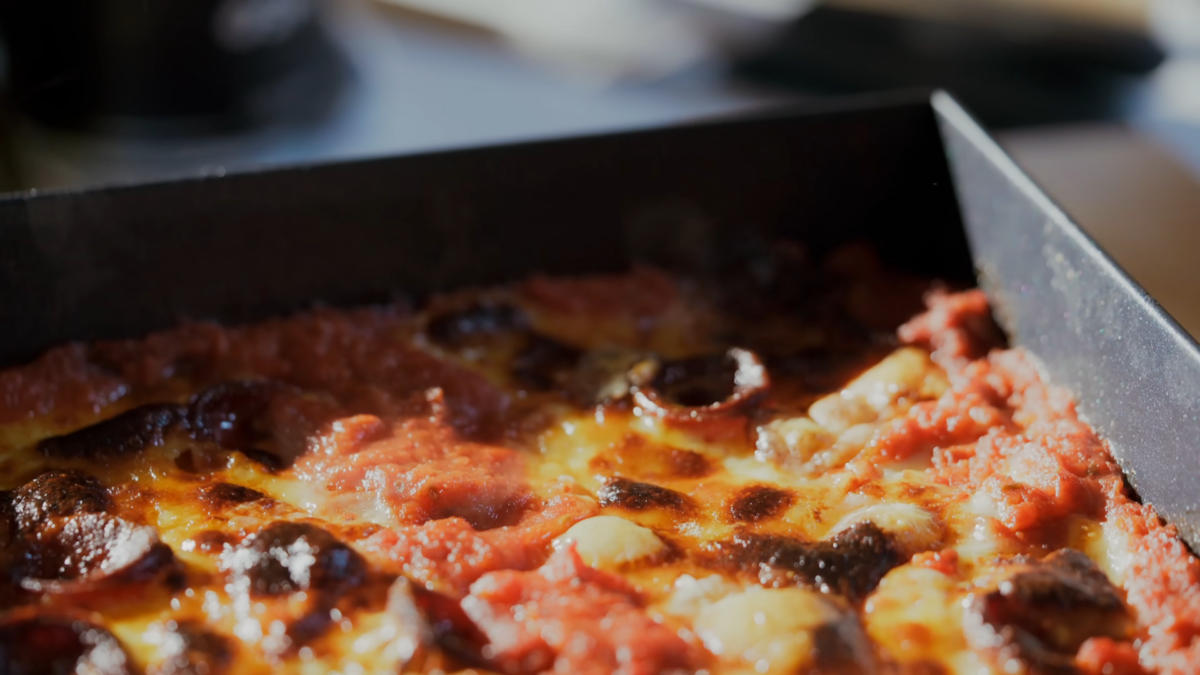 A cooked pizza in a rectangular dish.