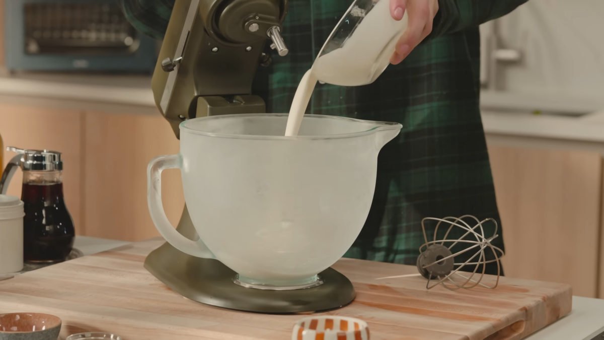 Heavy cream being poured into a chilled mixing bowl.