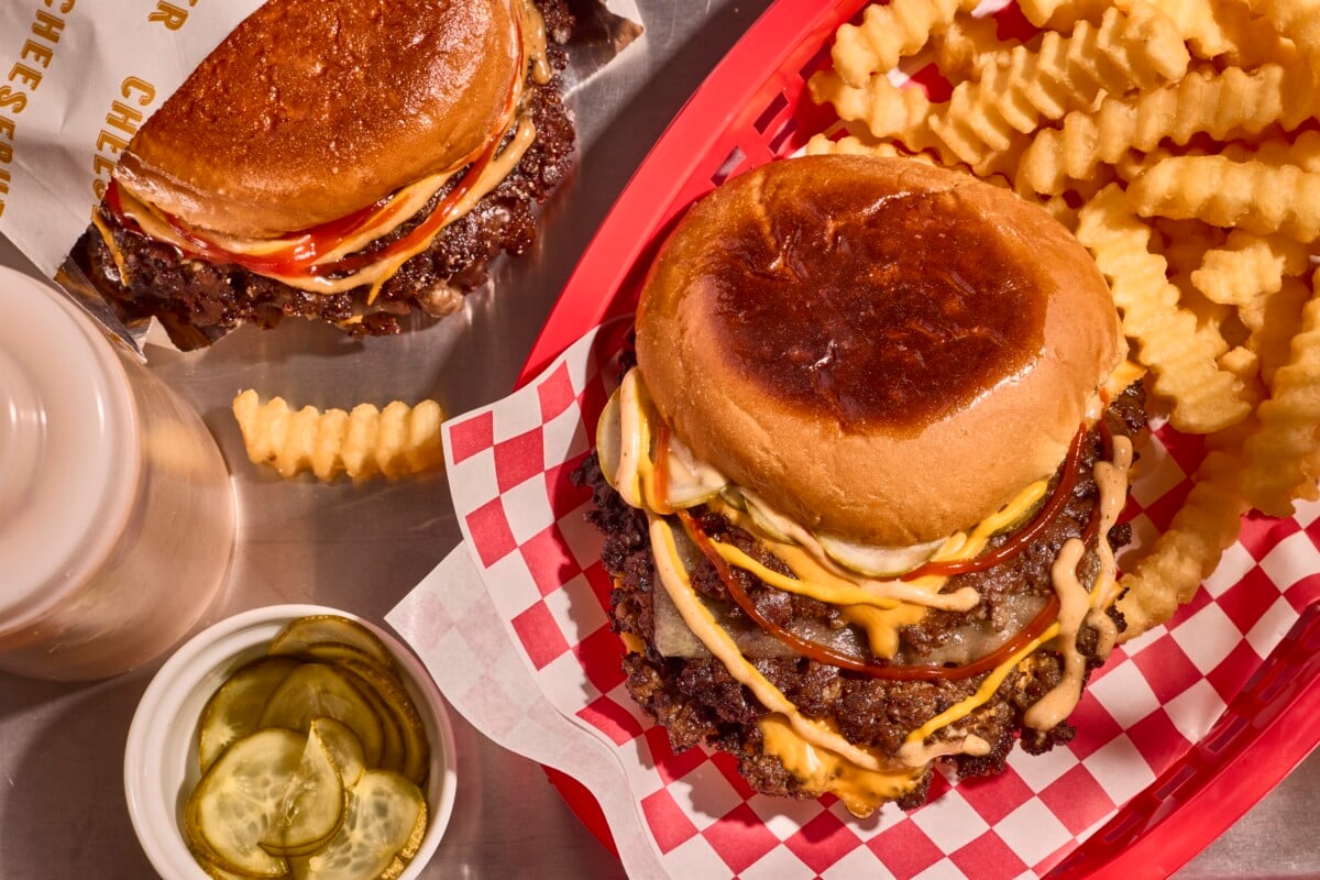 A smashburger in a basket with cries.