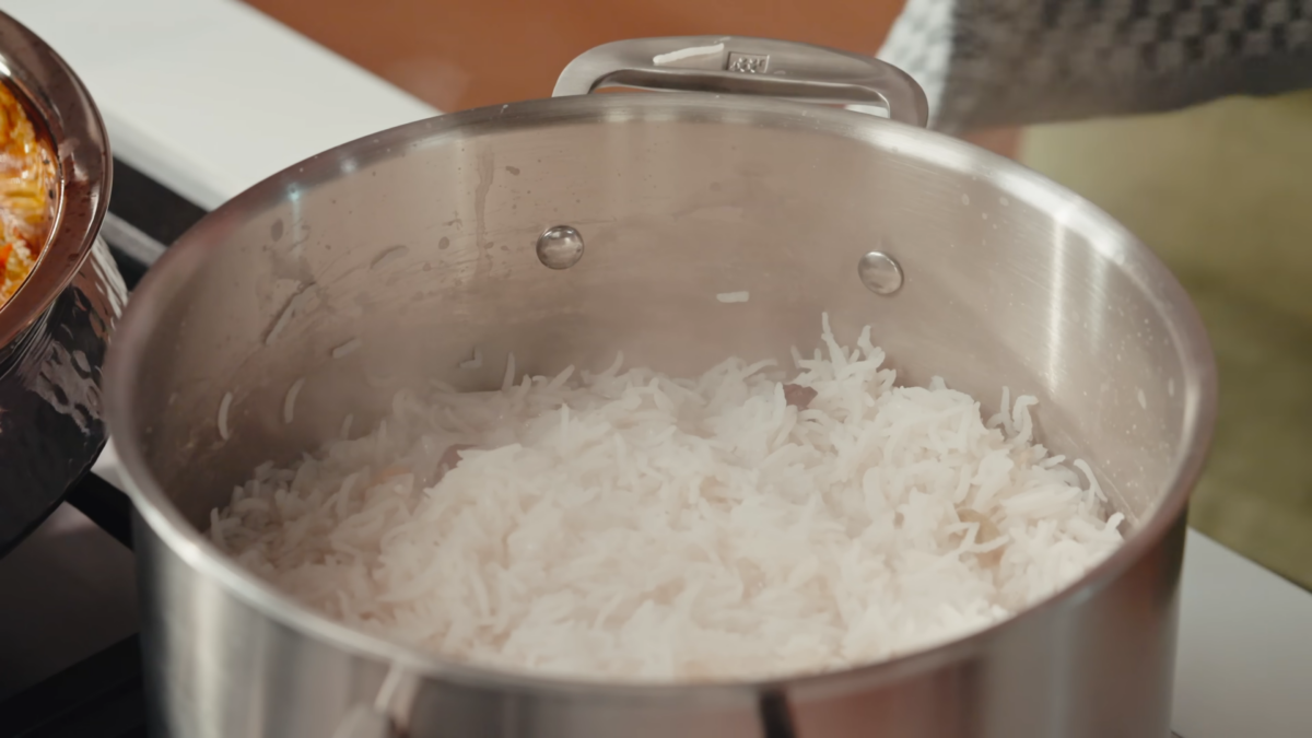 A pot of cooked long grain rice.