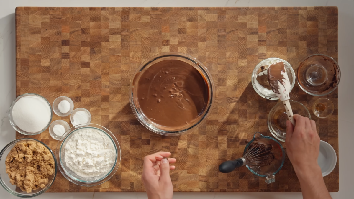A glass mixing bowl of melted chocolate.