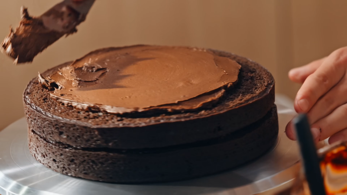 Chocolate frosting spread between cake layers.