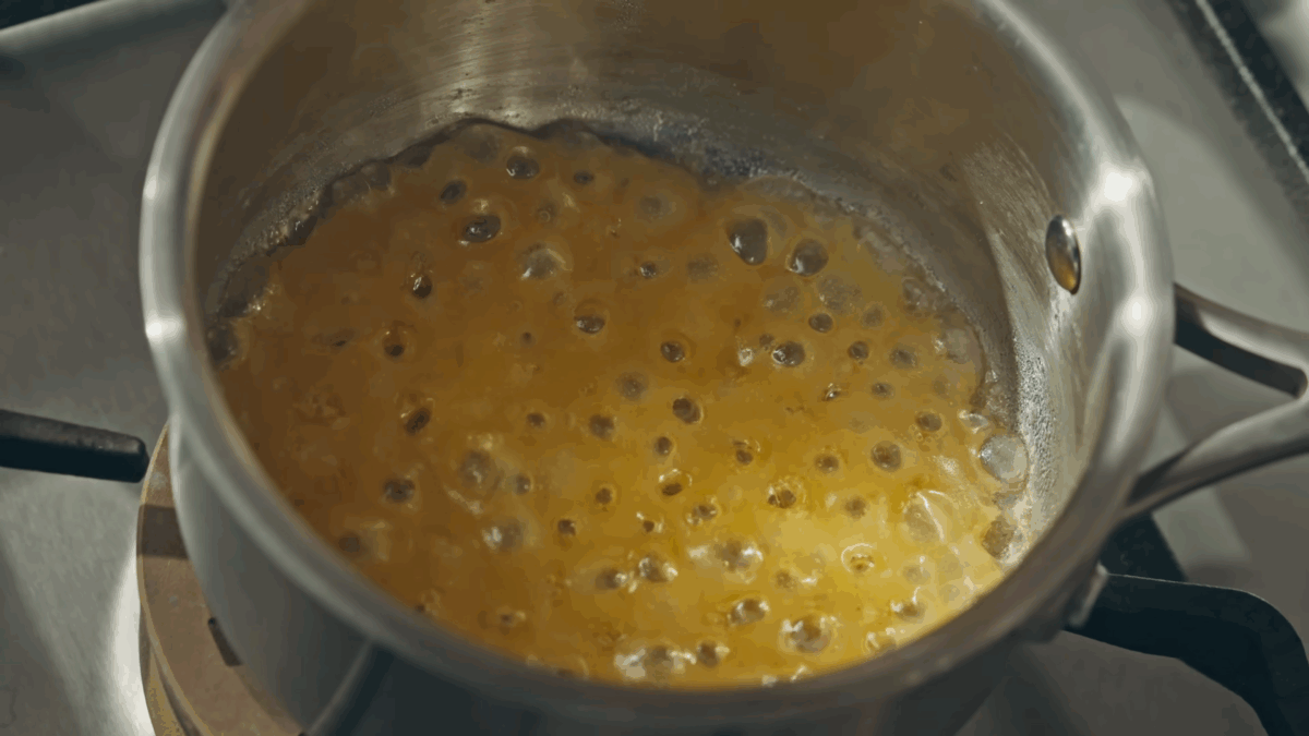 A pot of bubbling caramelizing sugar.