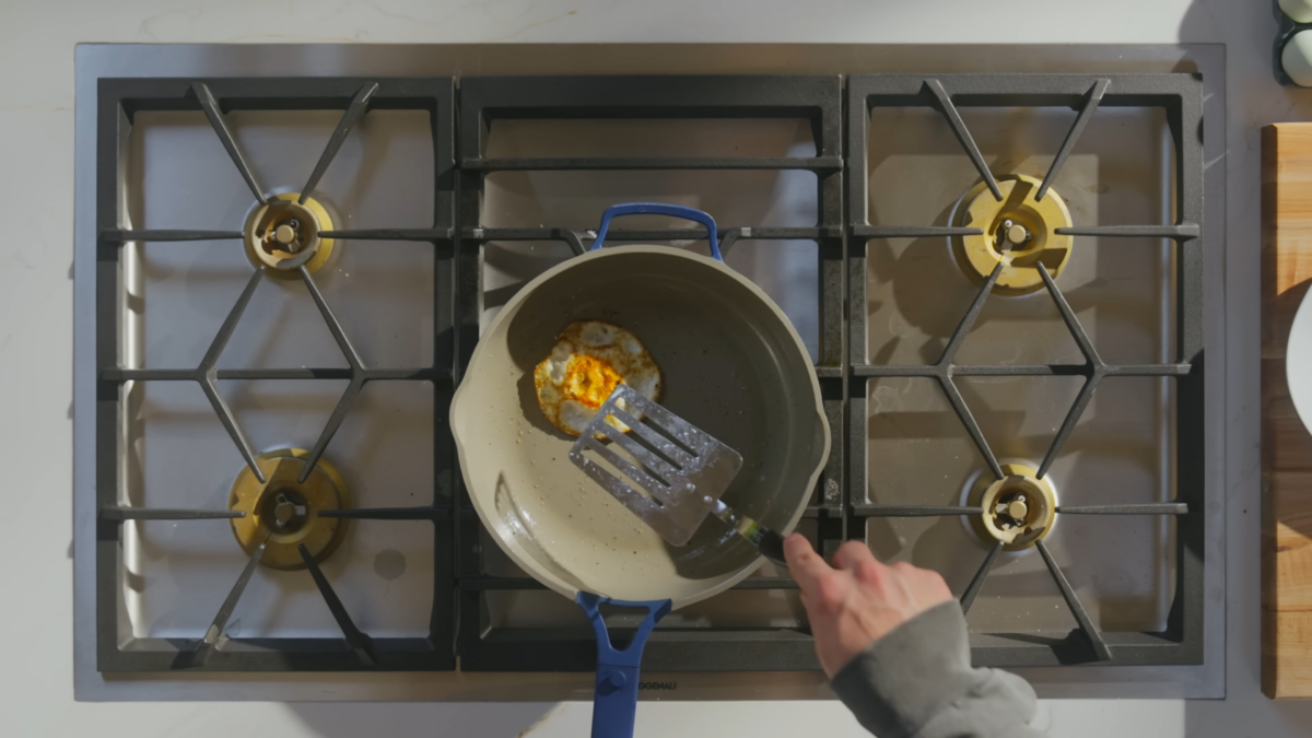 An over hard egg on a skillet.