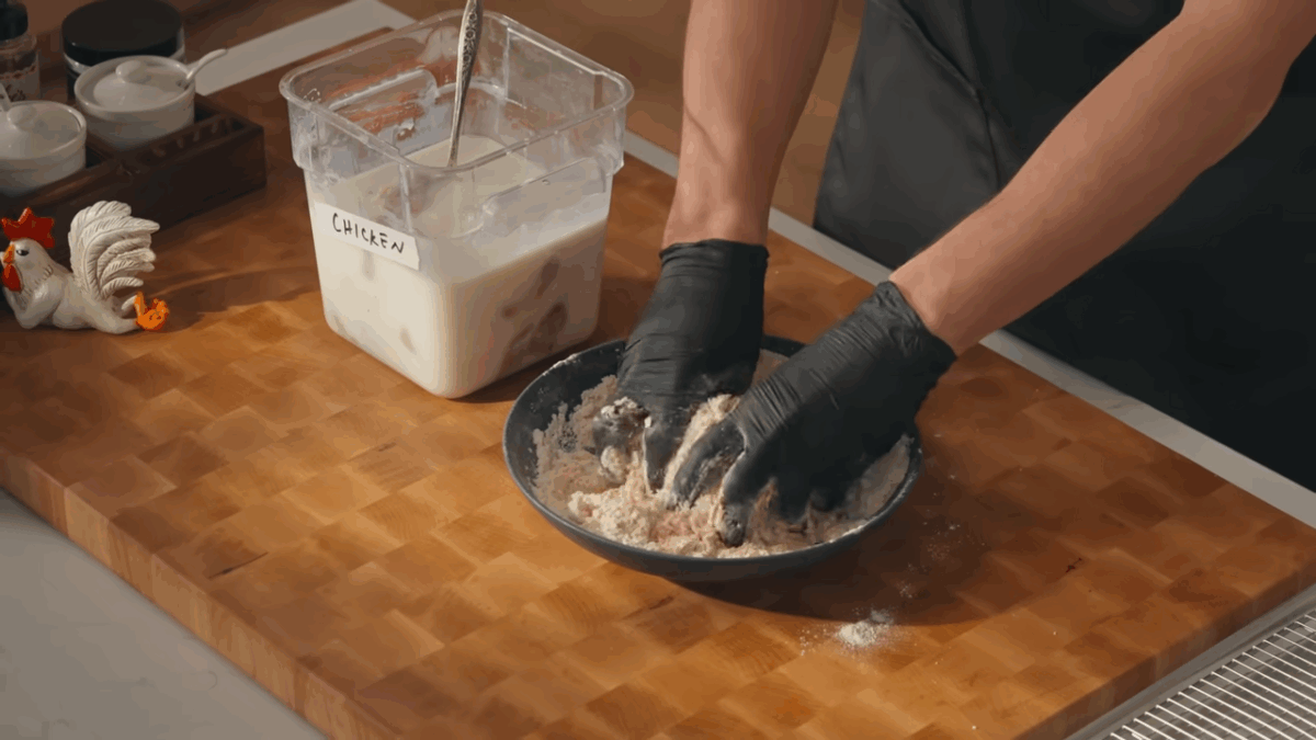 A dredging station with a buttermilk mixture and a flour mixture.