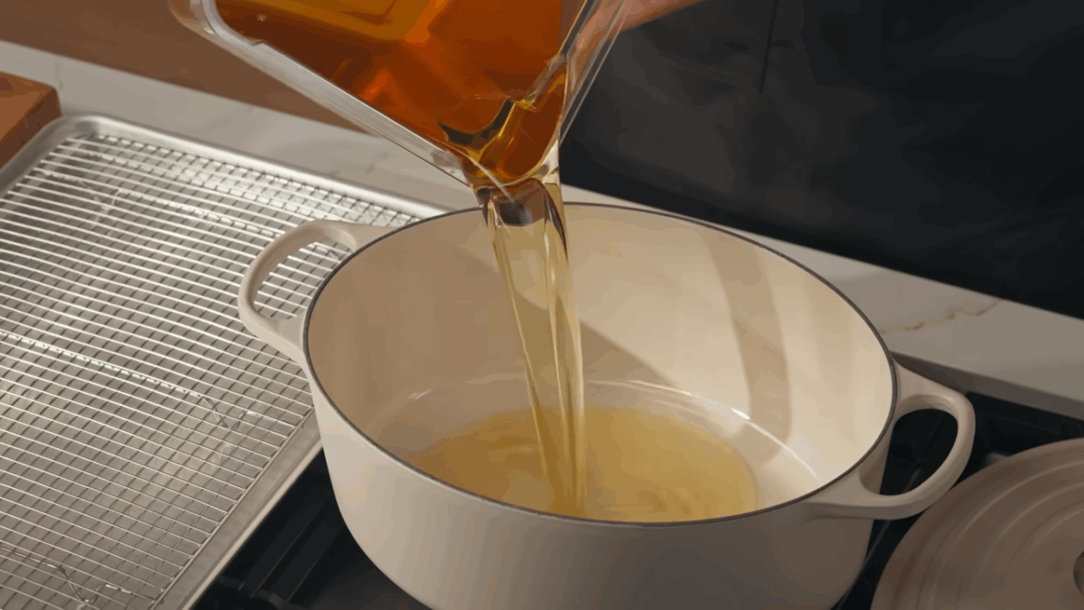 Oil being heated in a large Dutch oven.
