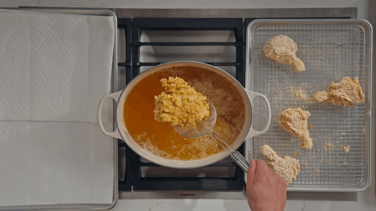 Chicken being fried in oil.