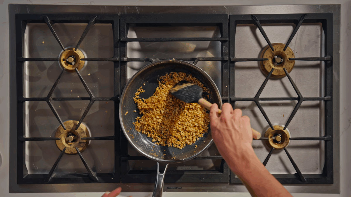 A pangratto (breadcrumb) topping browning in a skillet.