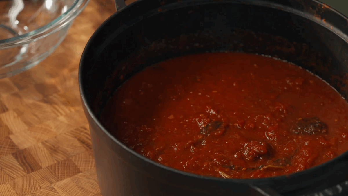 Spaghetti sauce simmering in a Dutch oven.