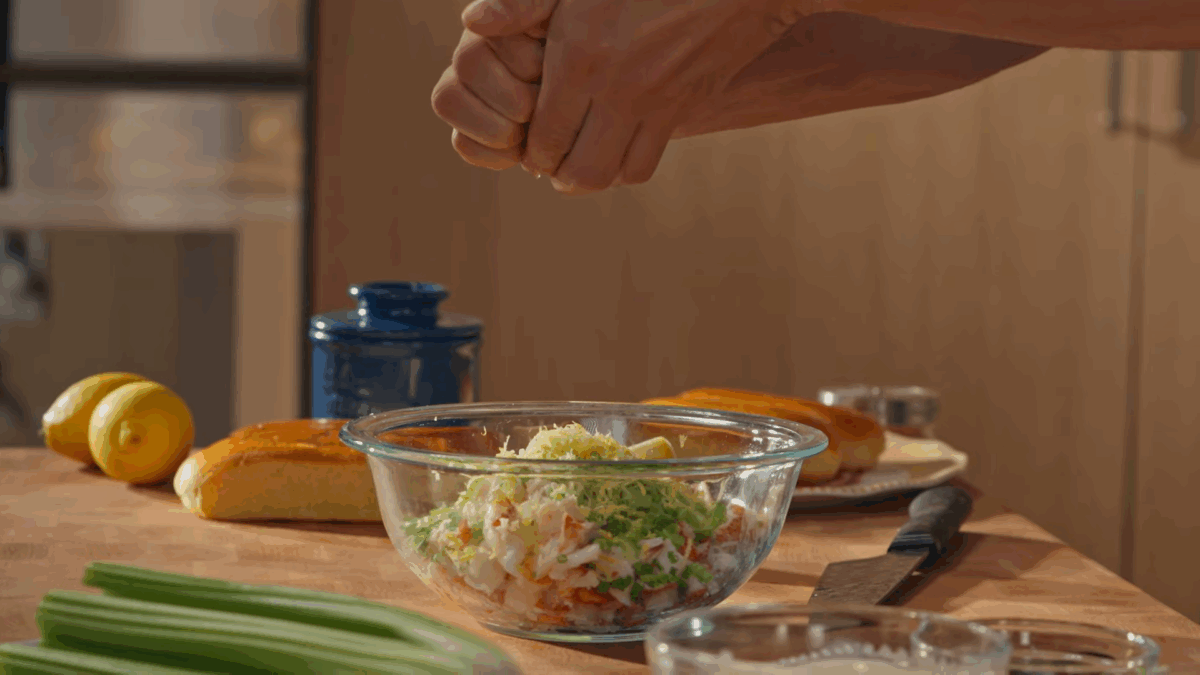 Lobster roll filling being combined in a bowl.