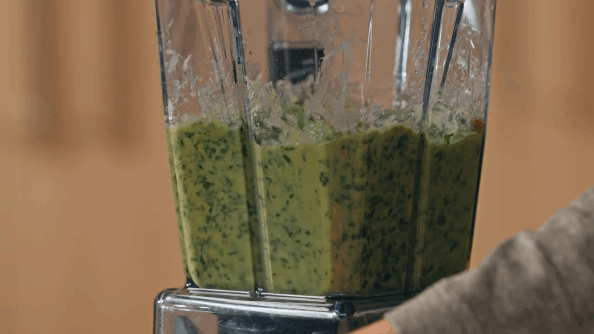 Basil pesto being blended. 