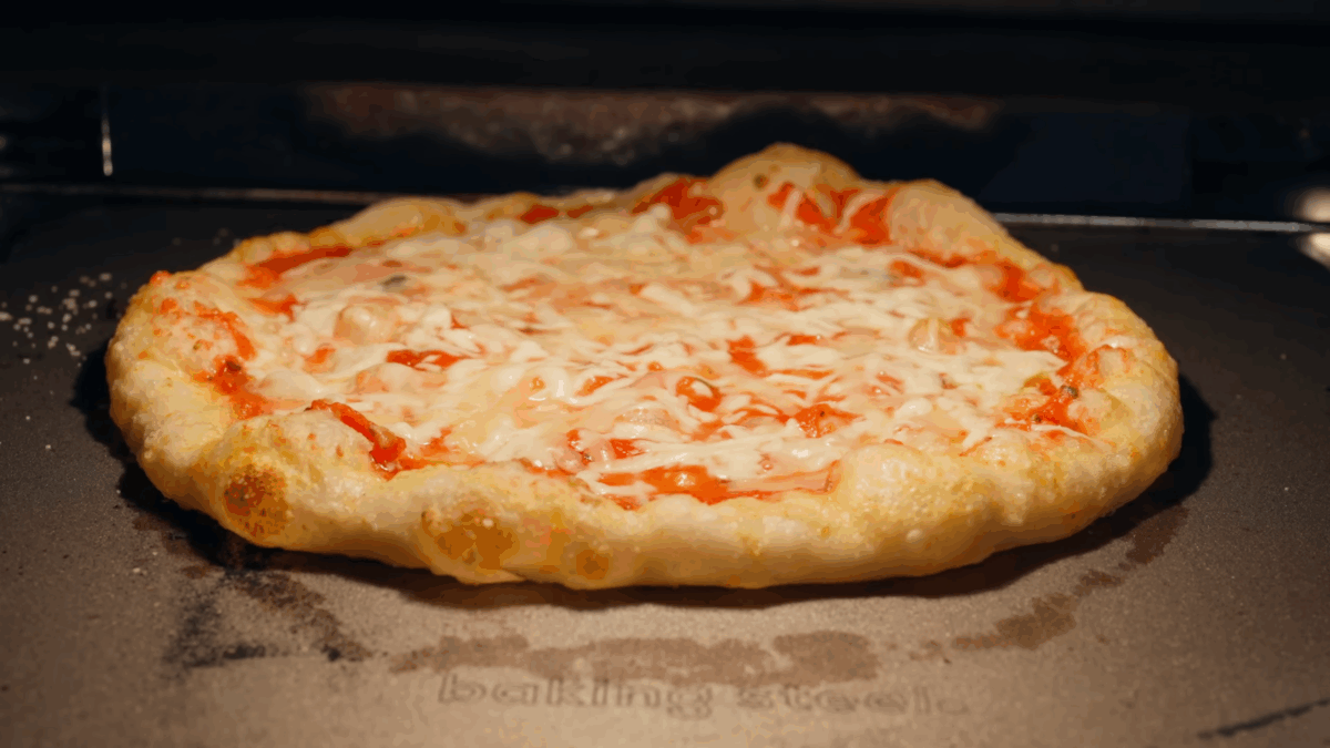 New York style pizza baking in an oven. 