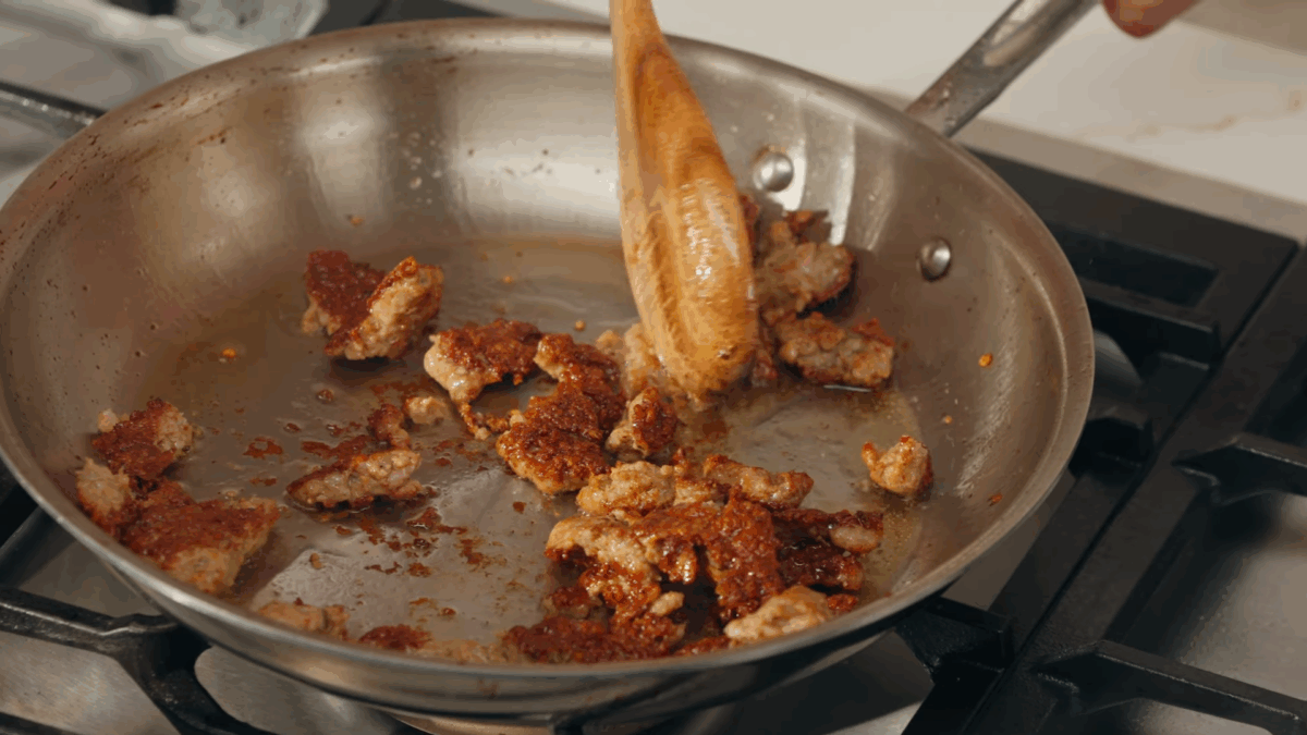 Sausage browning in a skillet. 
