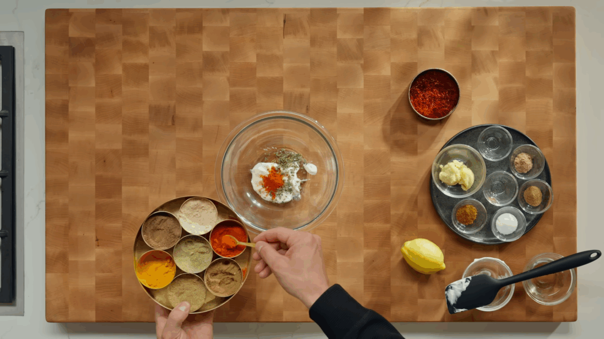 Butter chicken marinade ingredients being combined in a bowl.