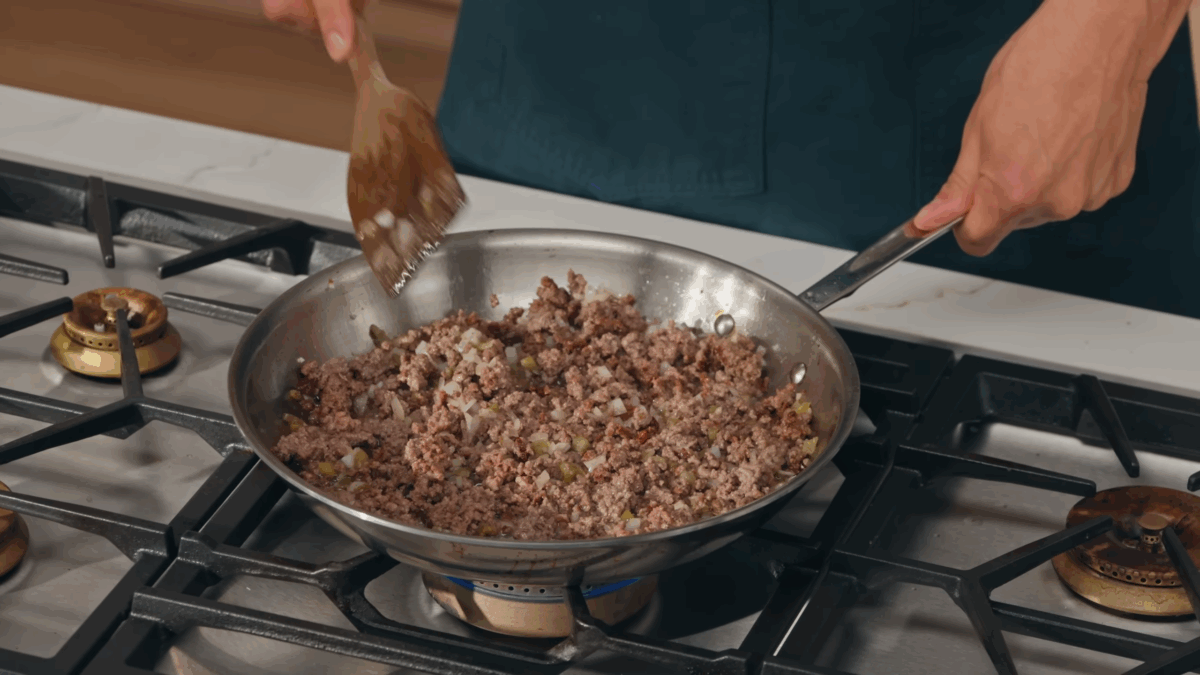 Beef and onions browning in a pan. 