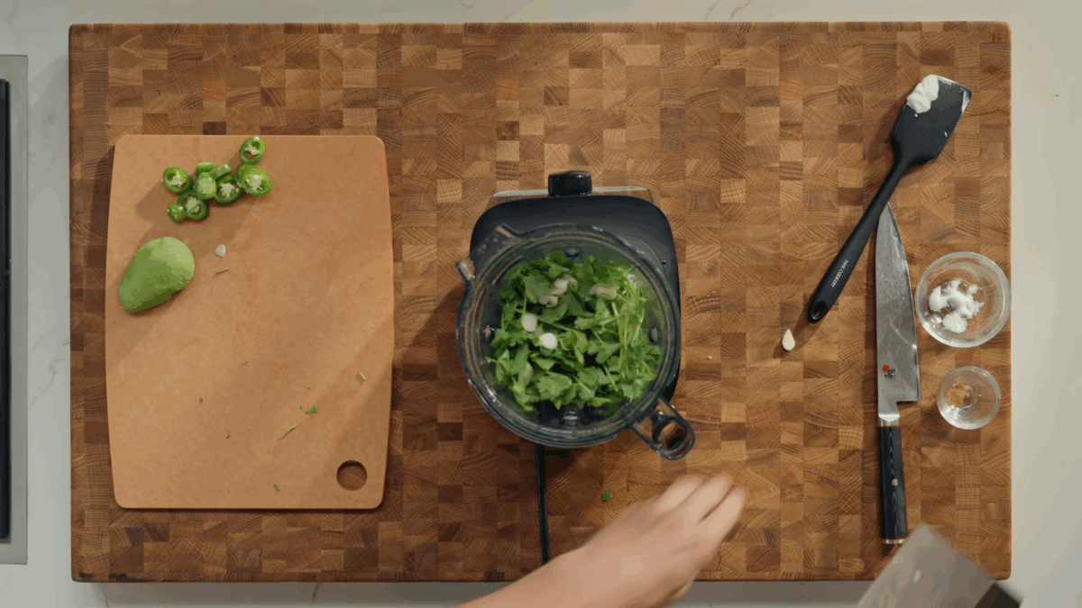Fresh ingredients being added to a blender. 