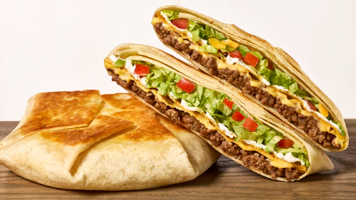 Two homemade crunchwrap supremes, one split in half.