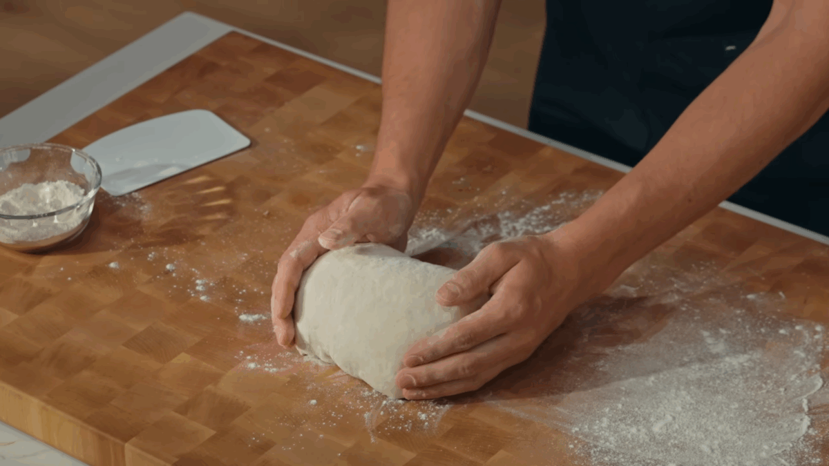 Nick DiGiovanni shaping sourdough bread dough into a boule.