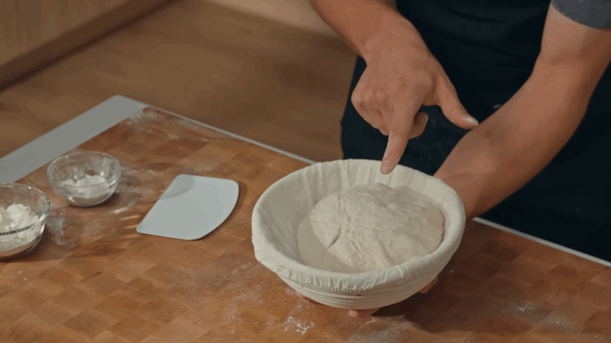 Nick DiGiovanni transferring sourdough bread dough to a proofing basket.