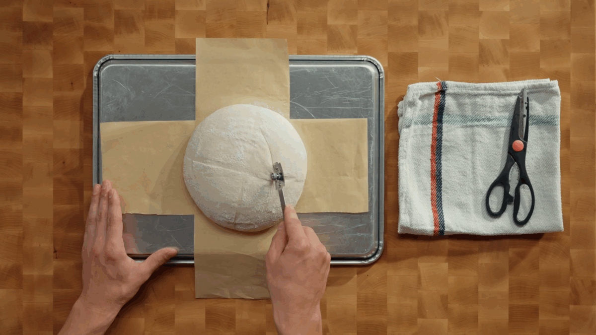 Nick DiGiovanni scoring a sourdough bread dough loaf.