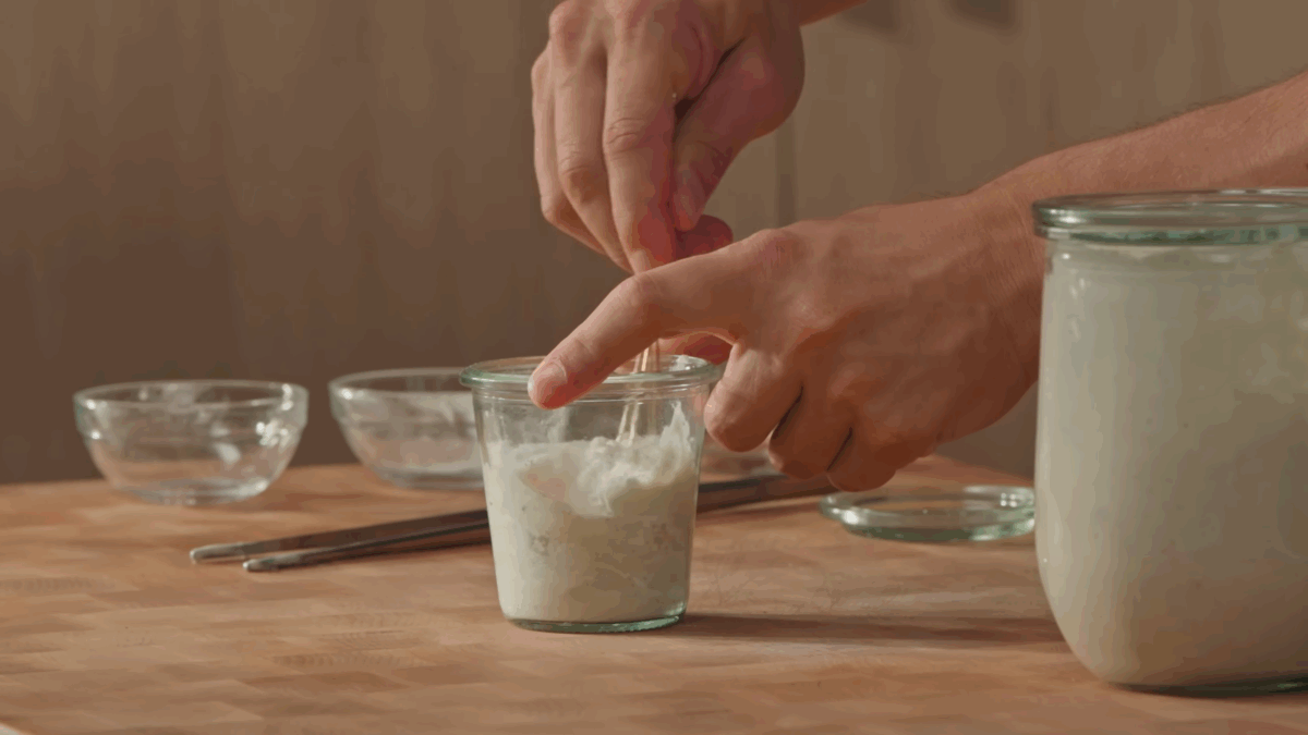 Nick DiGiovanni stirring sourdough levain.
