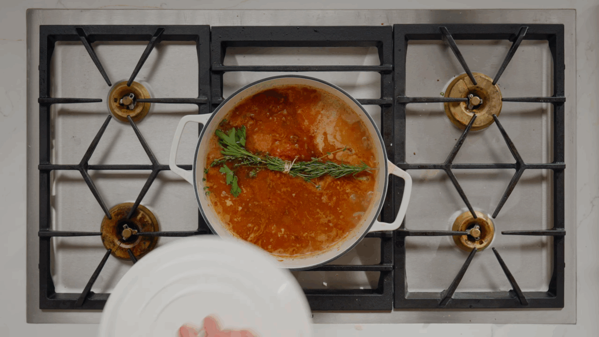 Bolognese sauce simmering in a Dutch oven.