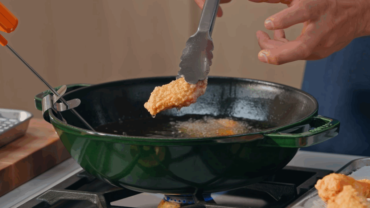 Nick DiGiovanni frying chicken wings on the stovetop.
