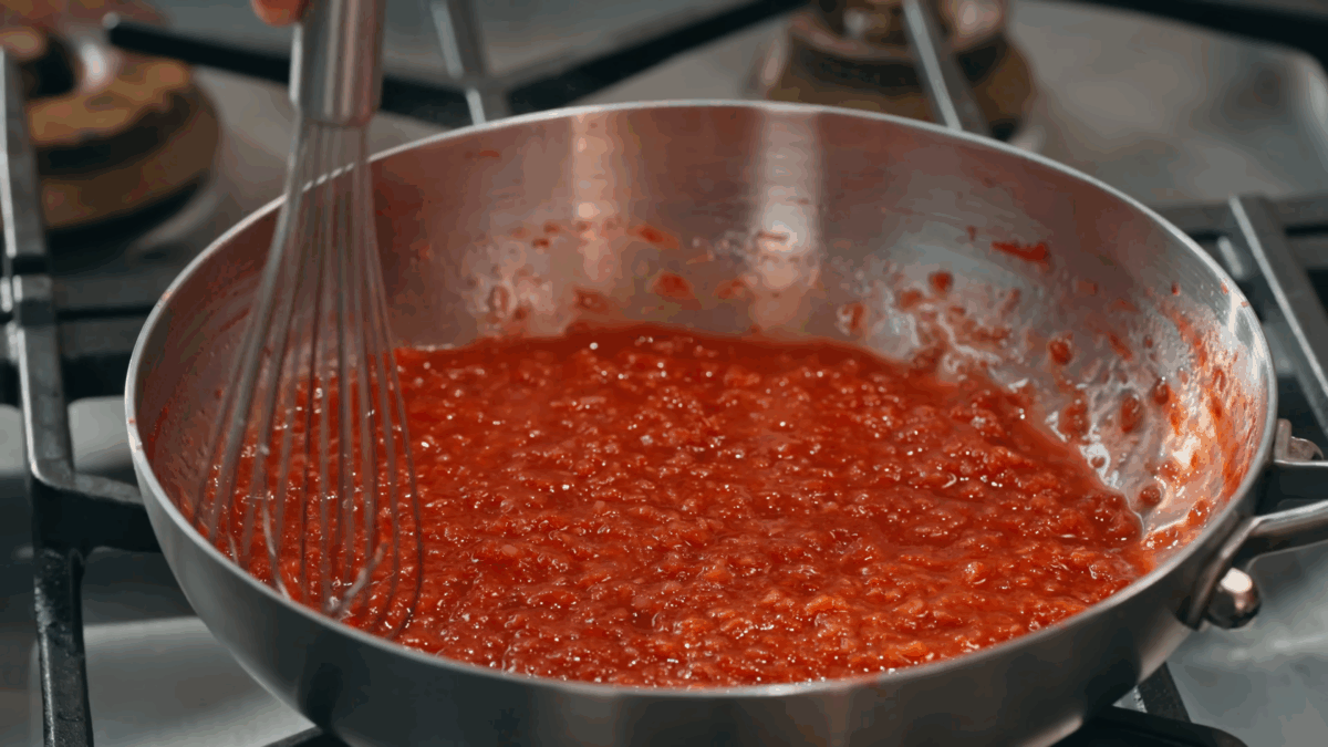 Nick DiGiovanni cooking raspberry coulis on the stovetop.