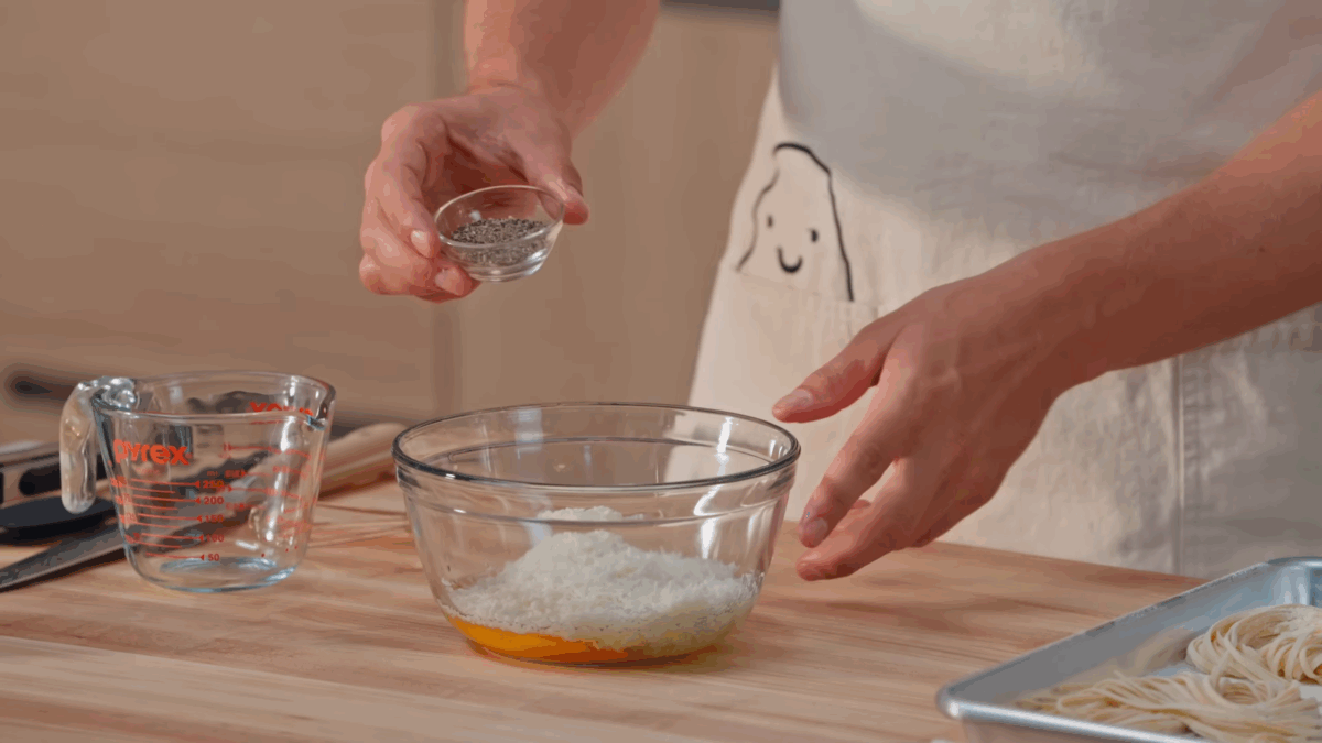 Nick DiGiovanni whisking ingredients for pasta carbonara sauce.