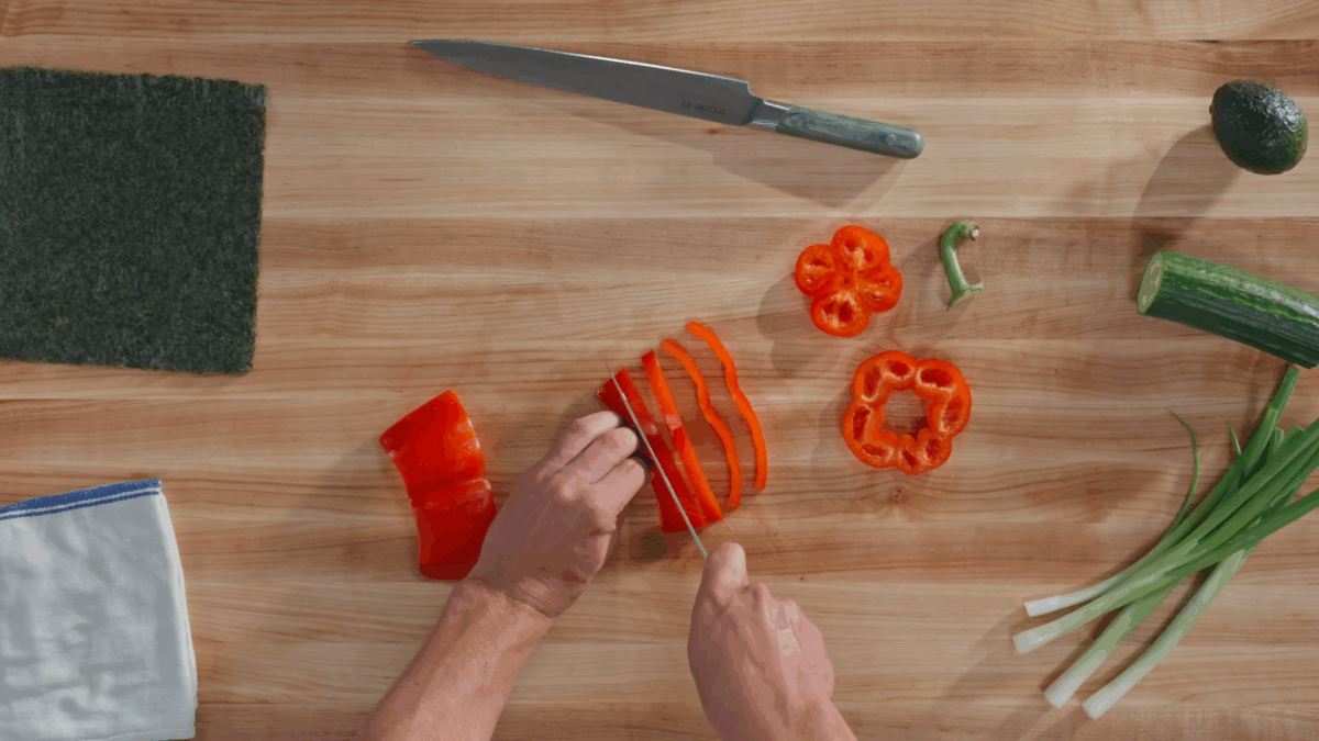 Nick DiGiovanni slicing a red bell pepper.