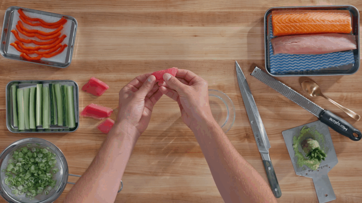 Nick DiGiovanni shaping a piece of nigiri between his hands.